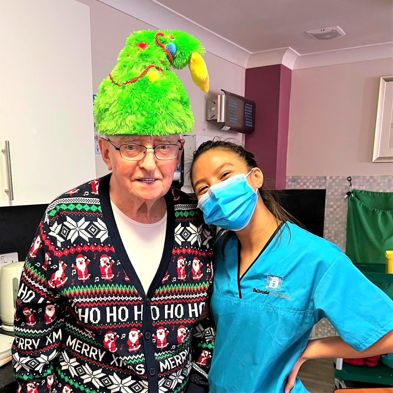 Resident wearing tree hat with carer