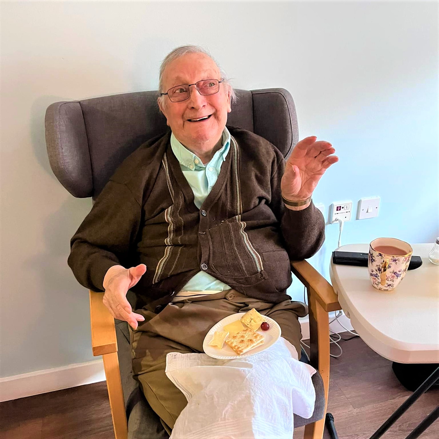 Resident enjoying cheese and crackers