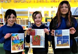 three children holding up their Christmas card designs.