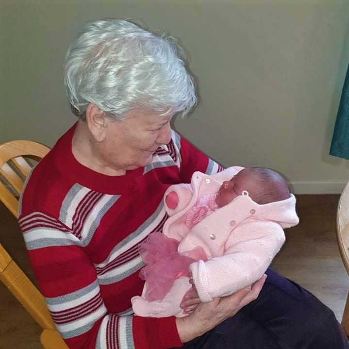 Antiquary - resident holding baby girl
