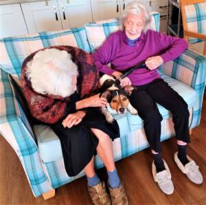 The Glens - two residents with dog on sofa