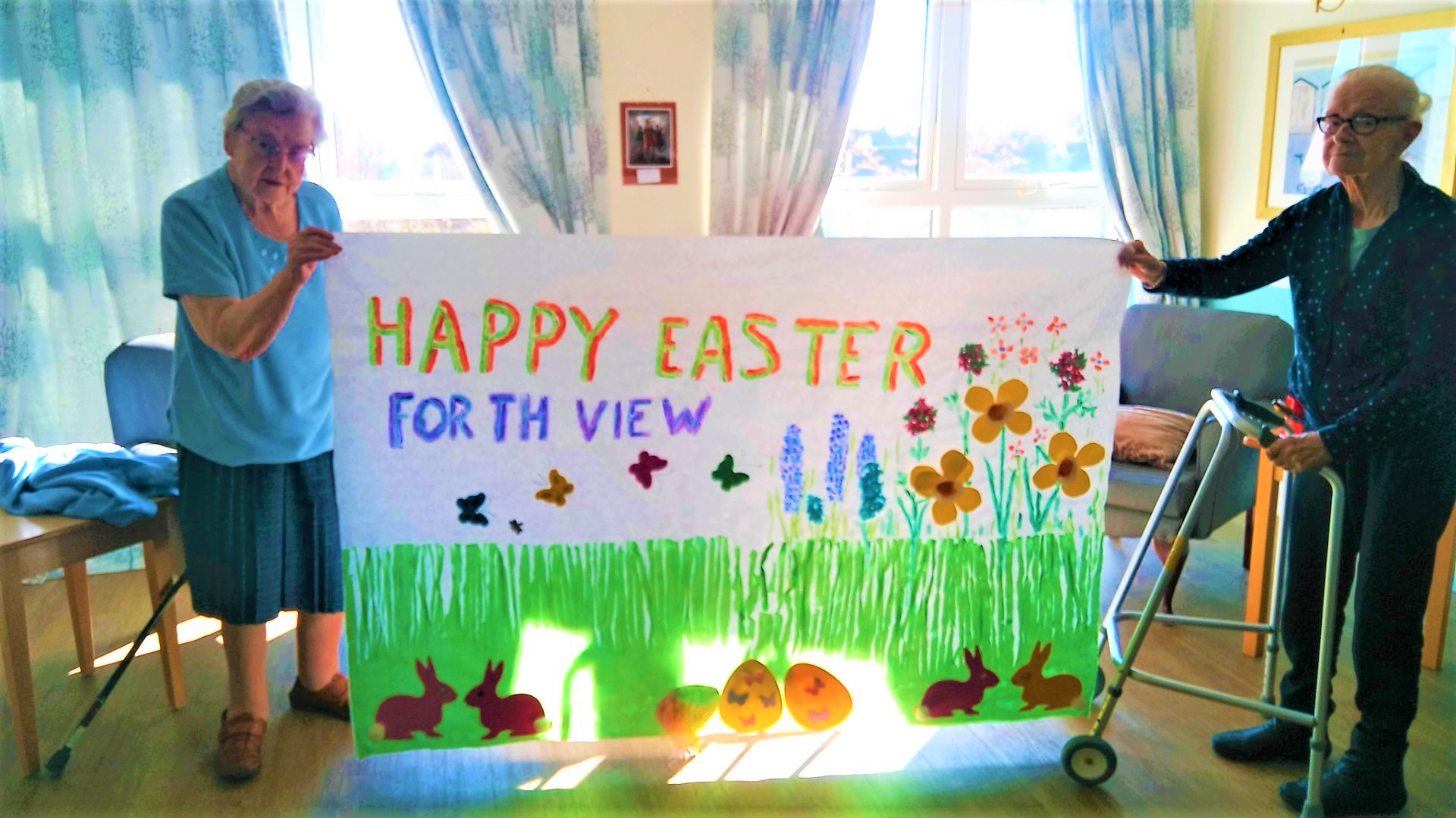 Forth View - residents holding home madeEaster banner