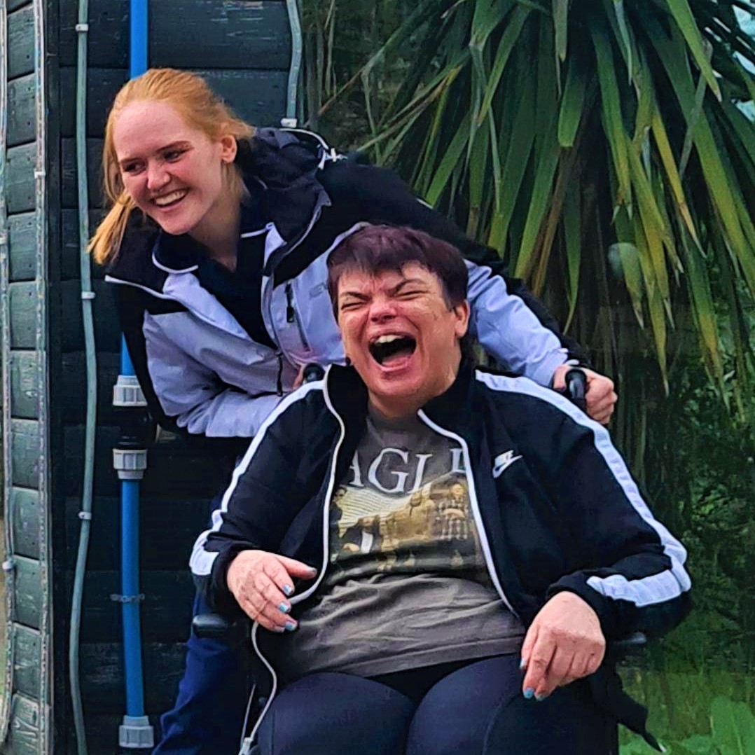 resident in wheelchair with staff laughing at the zoo