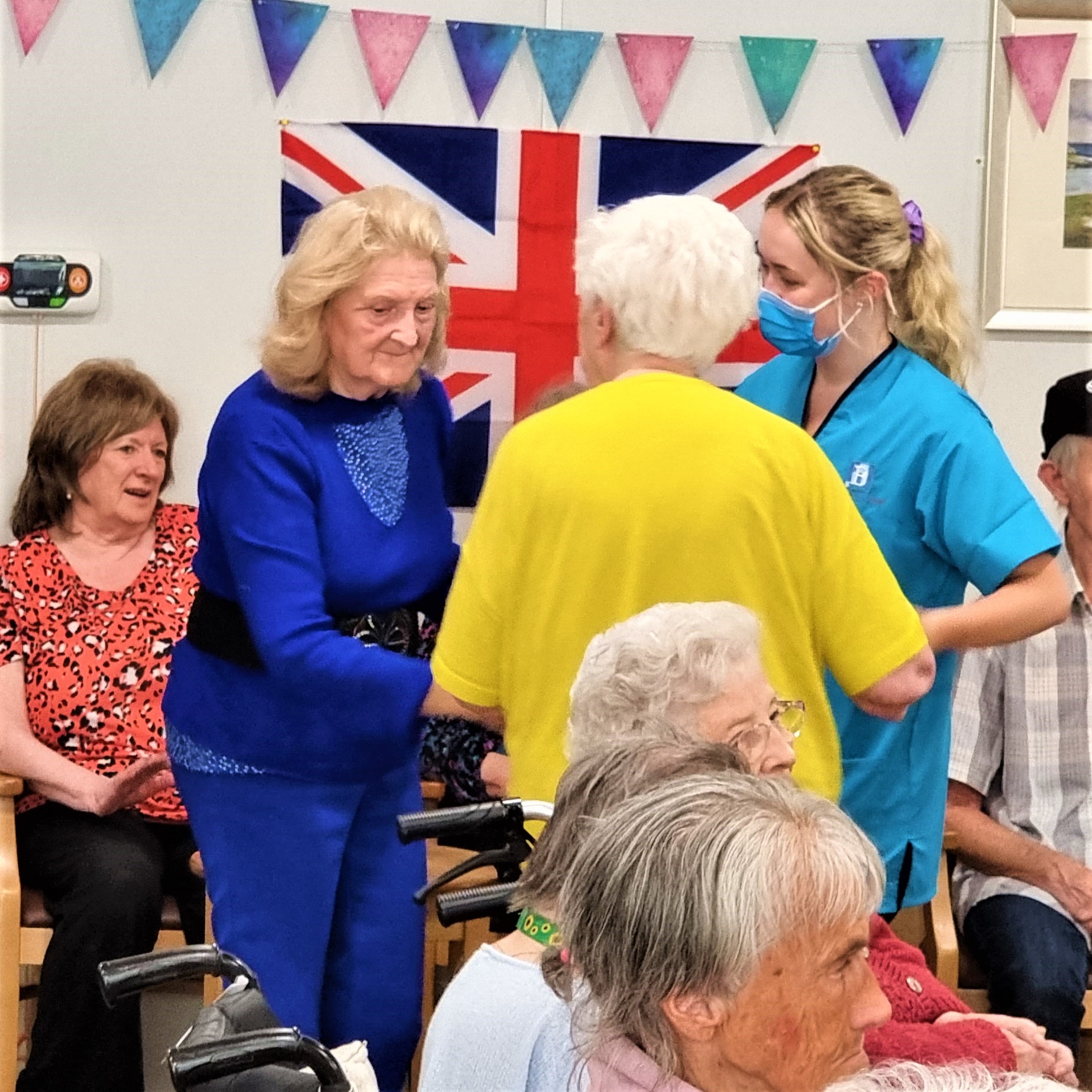 residents dancing with care assistant