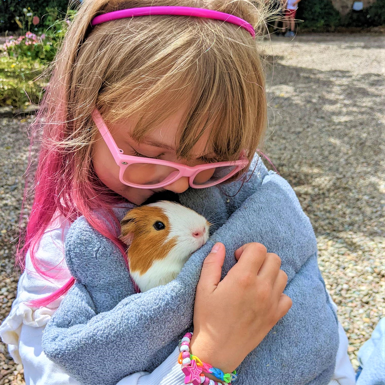 Brookfield - child cuddling a guinea pig