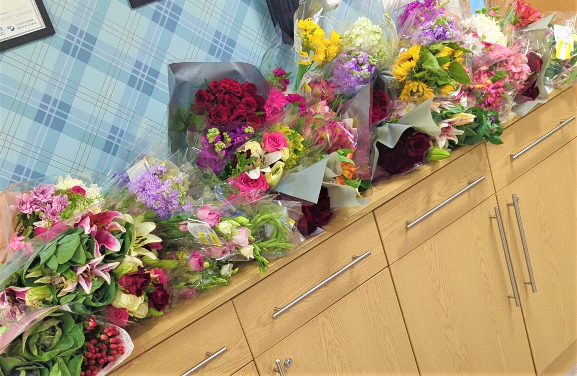 supermarket flower bunches on a sideboard