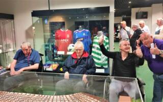 men inside Scottish Football museum