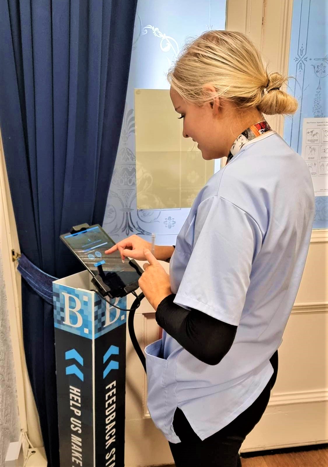 Balhousie care worker using feedback digital tablet