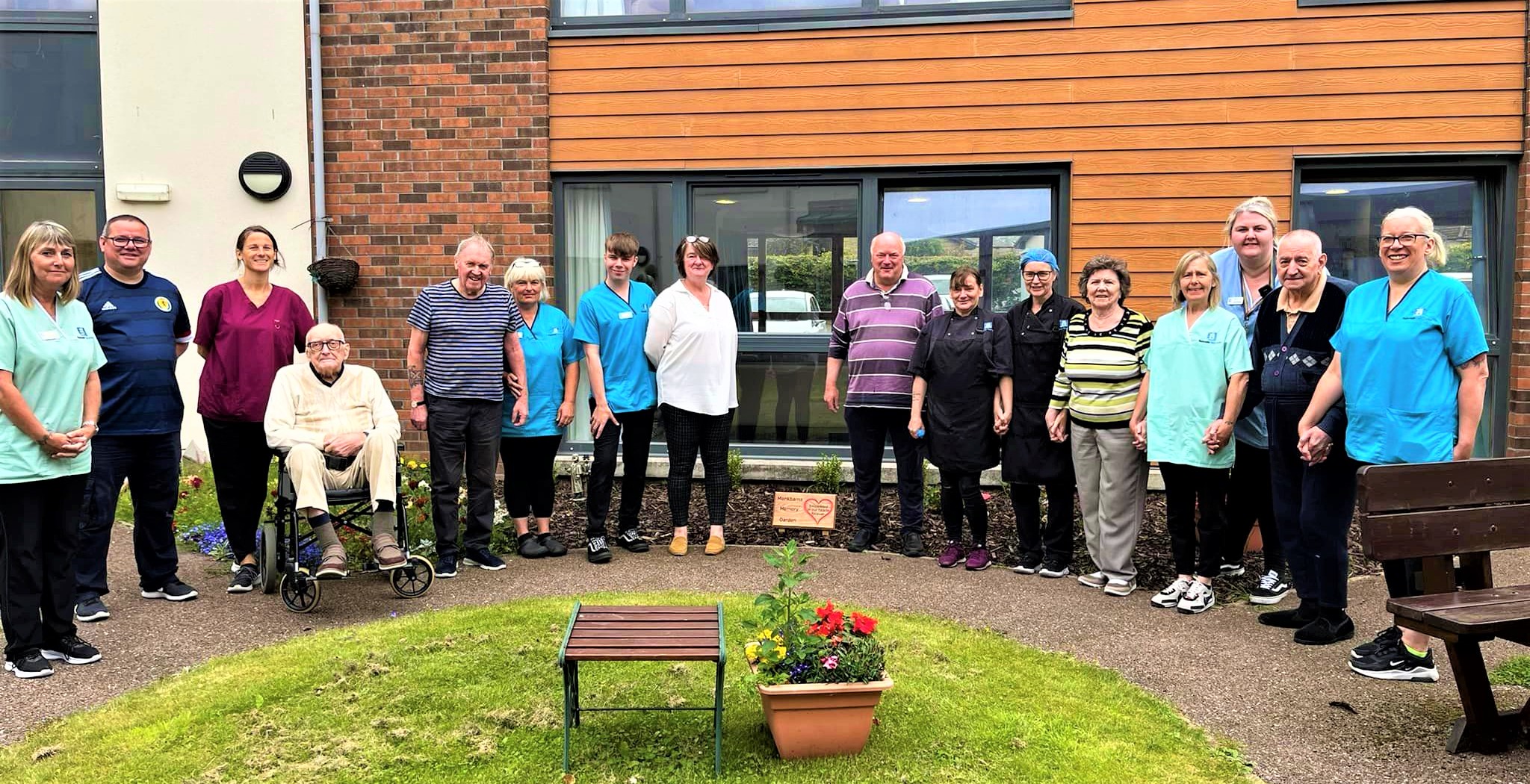 care staff standing in a new garden area